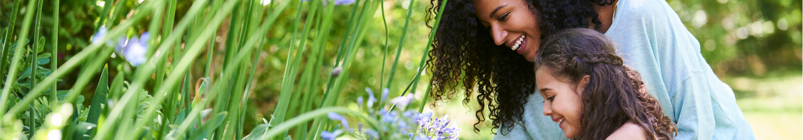 Mother and daughter picking flowers