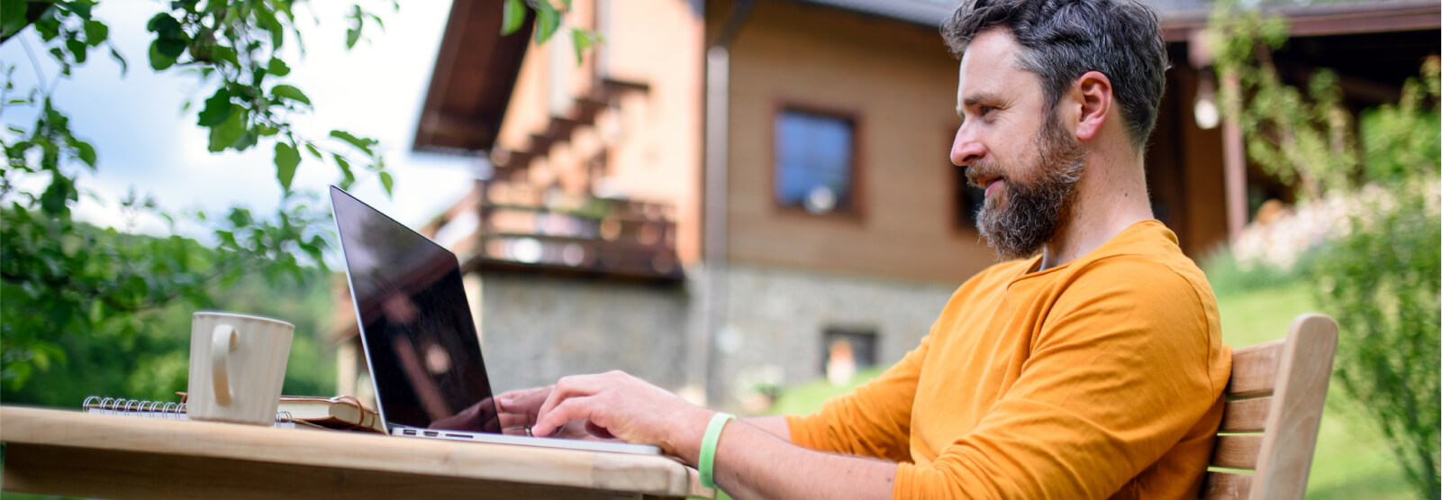 Man using a laptop outdoors