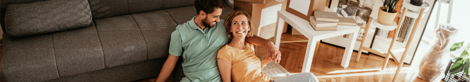 Couple sitting on the floor of a living room