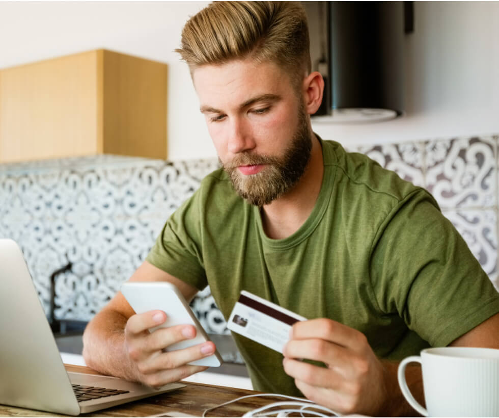 Man holding a smartphone and credit card